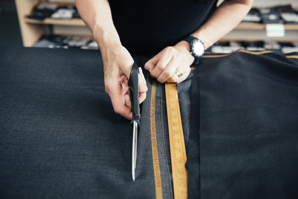 Tailor cutting fabric precisely along a marked line