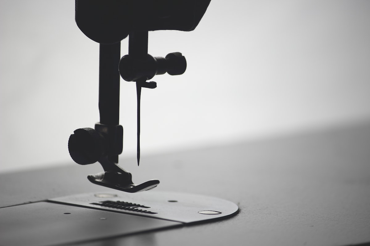 Macro photograph of a sewing needle and thread